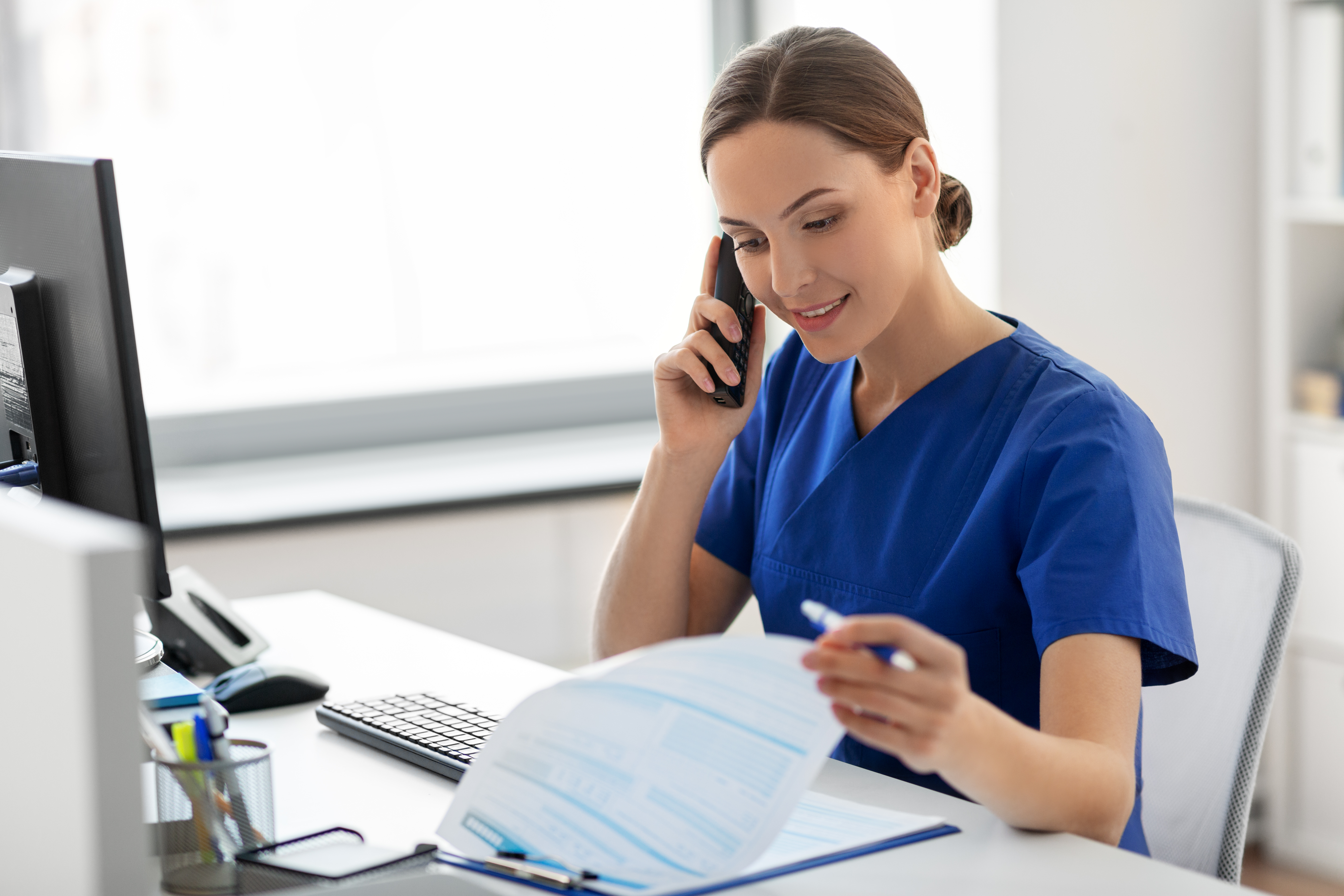 Dental team member reviewing documents during a HIPAA incident response